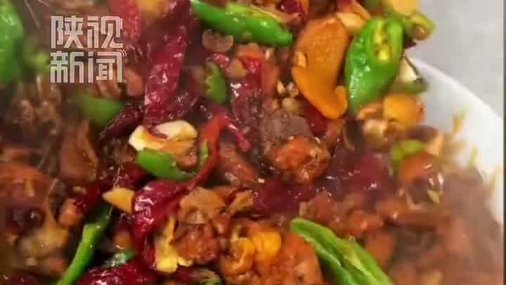 陕视新闻视频中盛有鸡肉、土豆和青椒的大盘鸡特写